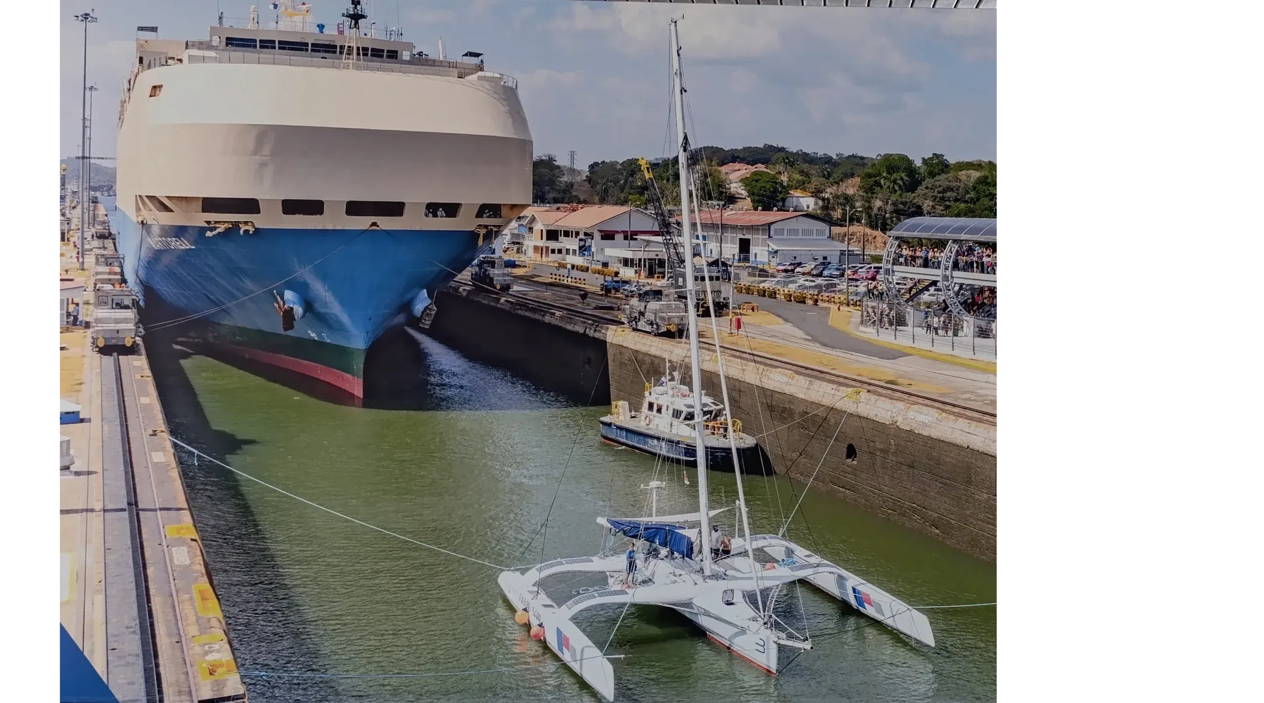 Cargo ship and sailboat at Panama Canal locks